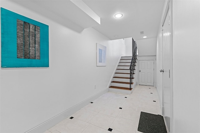 stairs featuring tile patterned floors