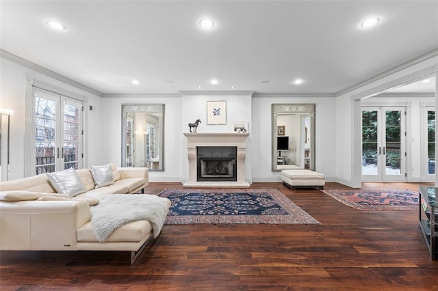 living room with hardwood / wood-style flooring, crown molding, and french doors