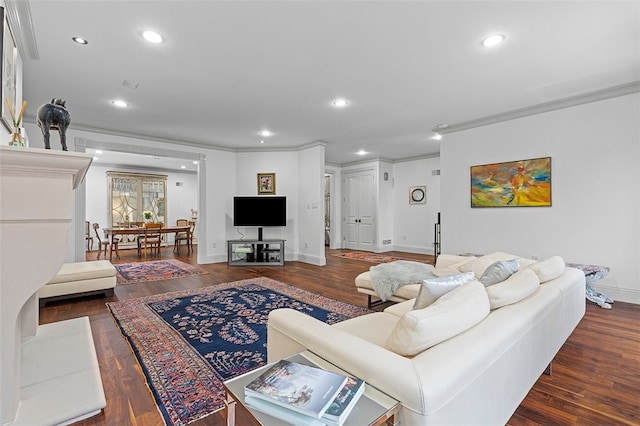 living room with dark hardwood / wood-style flooring and ornamental molding