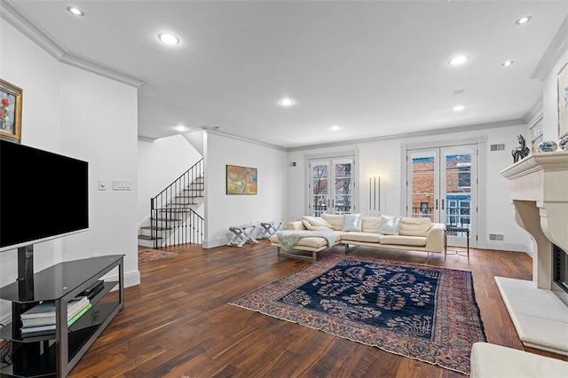 living room with dark hardwood / wood-style floors, ornamental molding, and french doors