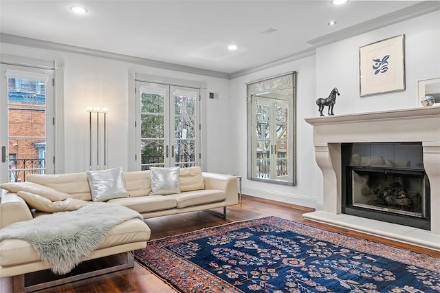 living room with wood-type flooring, ornamental molding, and french doors