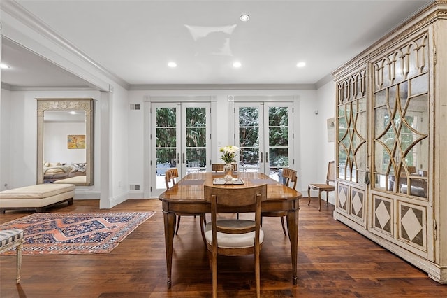 dining space featuring french doors, dark hardwood / wood-style flooring, and crown molding