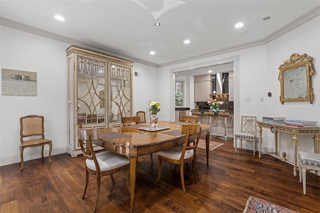 dining space with crown molding and dark wood-type flooring