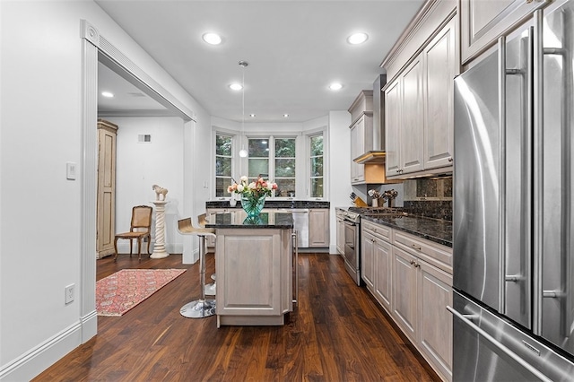 kitchen featuring a kitchen breakfast bar, a center island, dark hardwood / wood-style floors, and appliances with stainless steel finishes