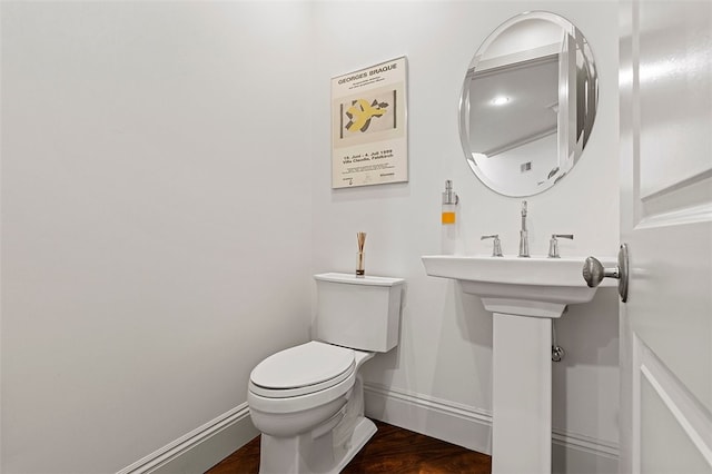 bathroom featuring hardwood / wood-style flooring and toilet