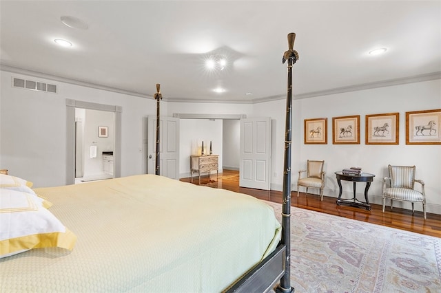 bedroom featuring crown molding and wood-type flooring