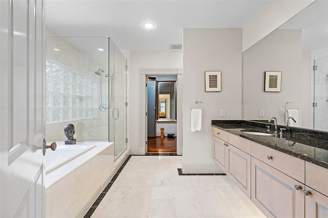 bathroom featuring plus walk in shower and vanity