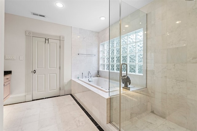 bathroom featuring tile patterned floors, vanity, and shower with separate bathtub