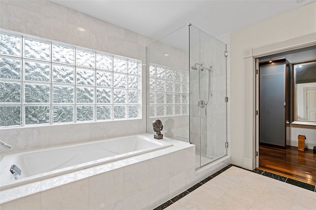 bathroom featuring plus walk in shower and tile patterned floors