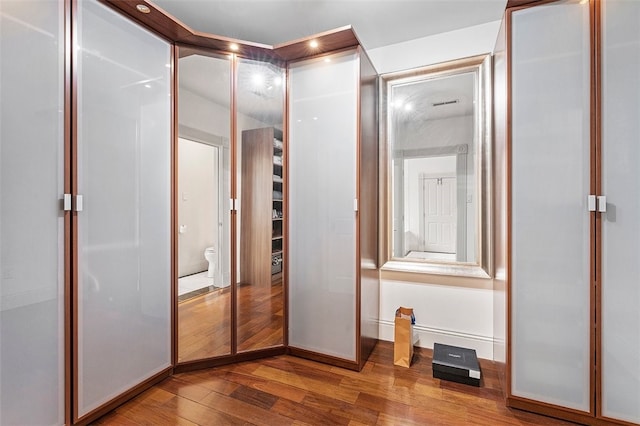 interior space featuring wood-type flooring and ensuite bathroom