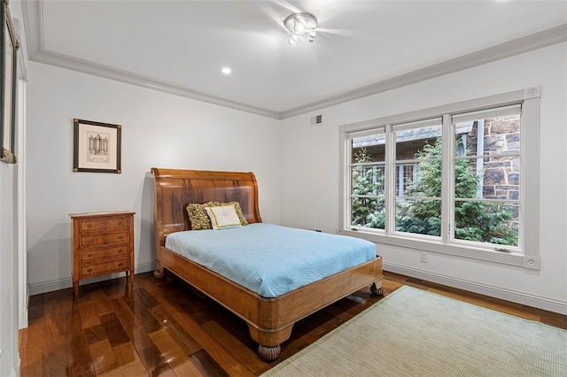 bedroom with crown molding and dark wood-type flooring