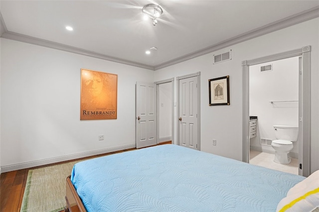 bedroom featuring hardwood / wood-style flooring, ensuite bathroom, and ornamental molding