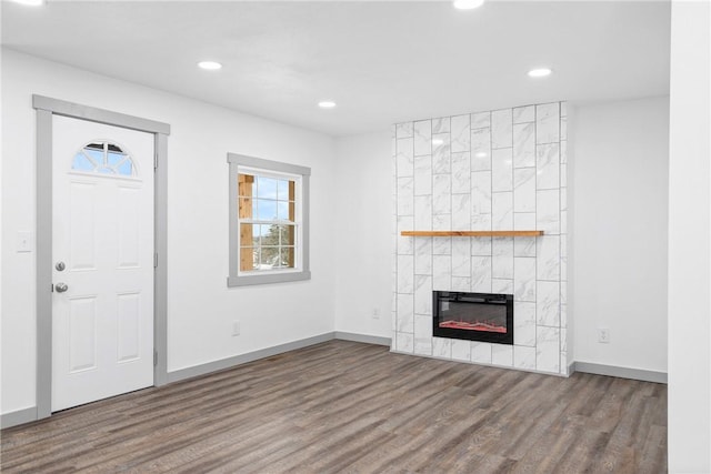 unfurnished living room featuring hardwood / wood-style flooring and a fireplace