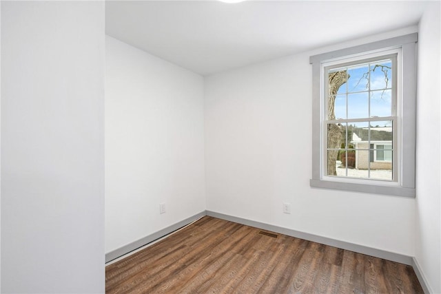 empty room with dark hardwood / wood-style floors