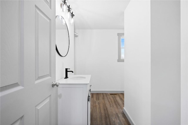 bathroom with hardwood / wood-style floors and vanity