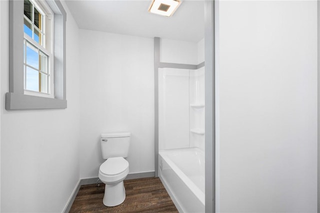 bathroom featuring shower / bathtub combination, toilet, and wood-type flooring