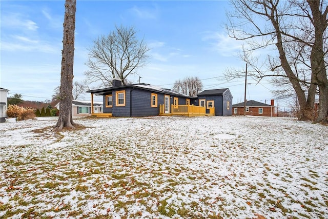 view of snow covered back of property