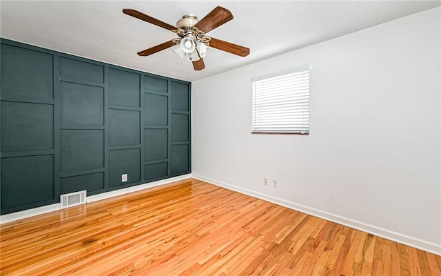 empty room featuring ceiling fan and light wood-type flooring