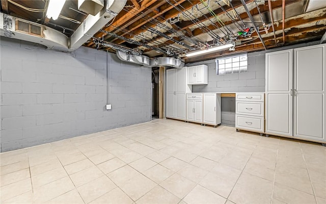 basement featuring light tile patterned floors