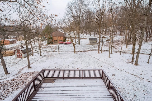 snow covered deck with a storage unit