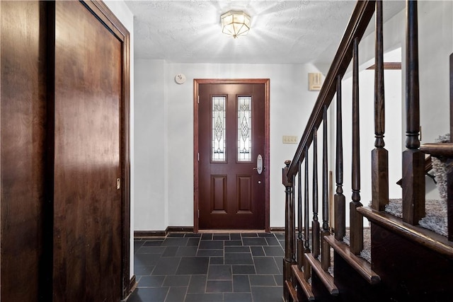 entryway with a textured ceiling