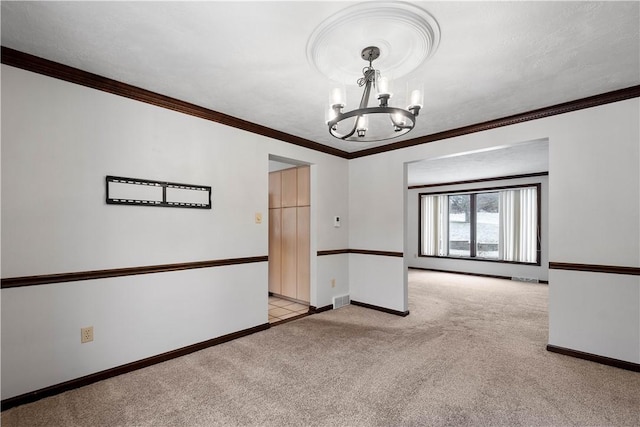 carpeted empty room featuring crown molding and a notable chandelier