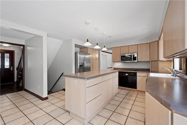 kitchen featuring light brown cabinets, sink, decorative light fixtures, a kitchen island, and stainless steel appliances