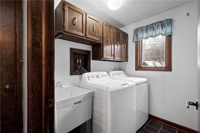 washroom with cabinets, separate washer and dryer, and sink