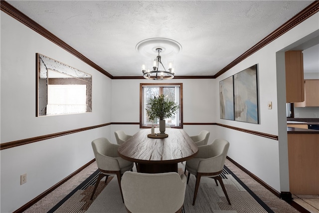 carpeted dining room featuring ornamental molding, a textured ceiling, and a notable chandelier