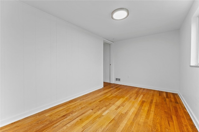 spare room with wood-type flooring