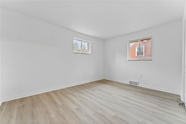 spare room featuring light hardwood / wood-style floors