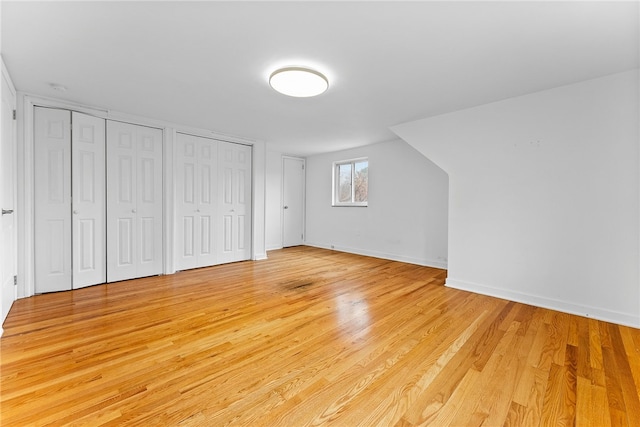 additional living space with light hardwood / wood-style flooring