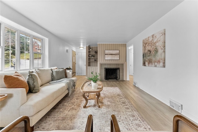 living room with a fireplace and light hardwood / wood-style flooring