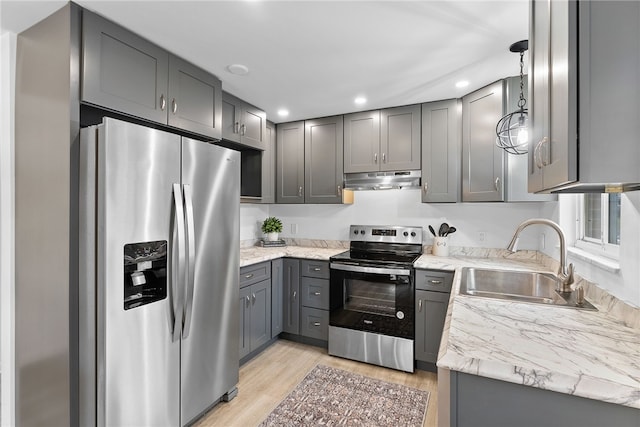 kitchen with stainless steel appliances, light hardwood / wood-style floors, gray cabinetry, and sink