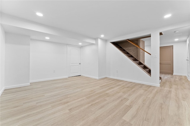 basement with light hardwood / wood-style floors