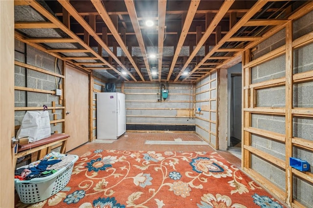 basement featuring white fridge