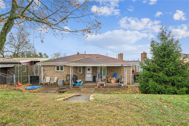 rear view of house featuring a patio area and a yard