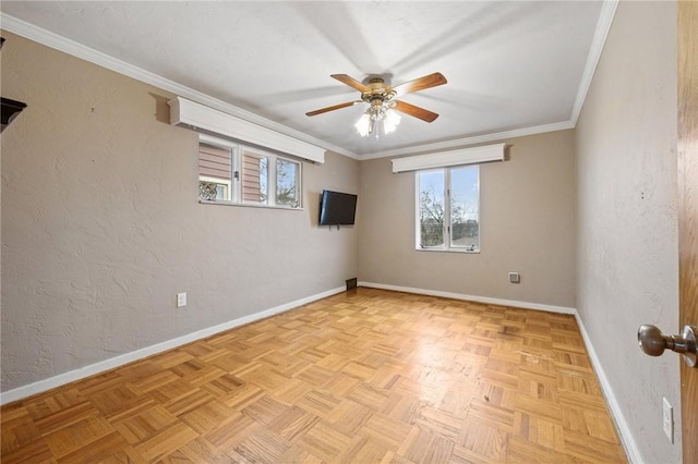 spare room featuring light parquet floors, ceiling fan, and crown molding