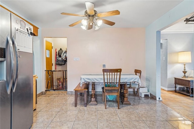 dining area featuring light tile patterned floors, ceiling fan, and crown molding