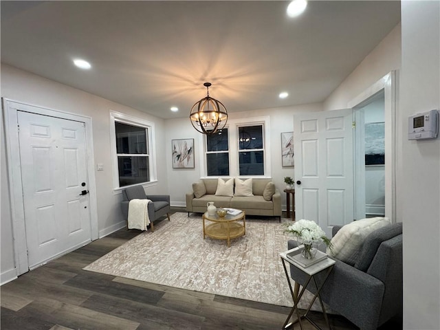 living room with a notable chandelier and dark hardwood / wood-style floors