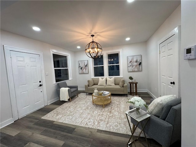 living room with dark wood-type flooring and a chandelier