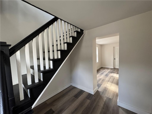 staircase featuring wood-type flooring