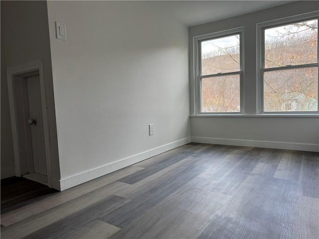 empty room with dark hardwood / wood-style flooring