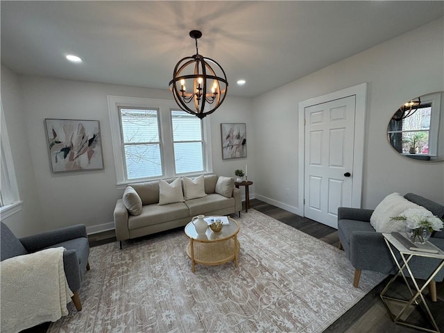 living room featuring dark hardwood / wood-style floors and an inviting chandelier