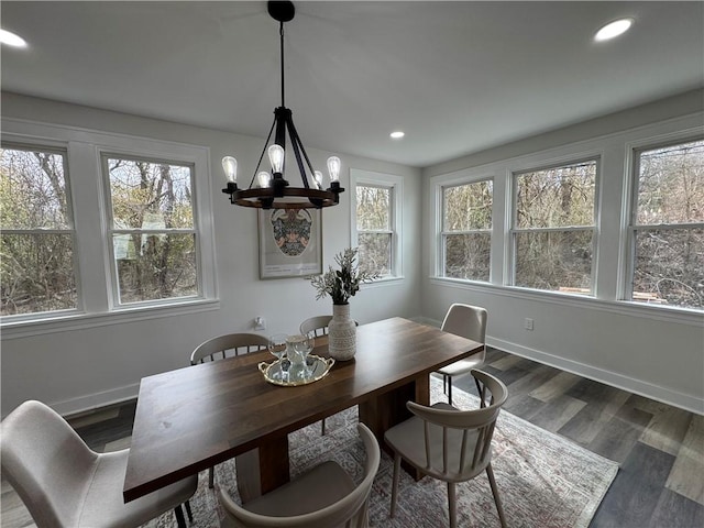 dining room featuring dark wood-type flooring and a notable chandelier