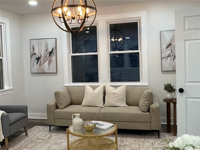 living room with a notable chandelier and wood-type flooring