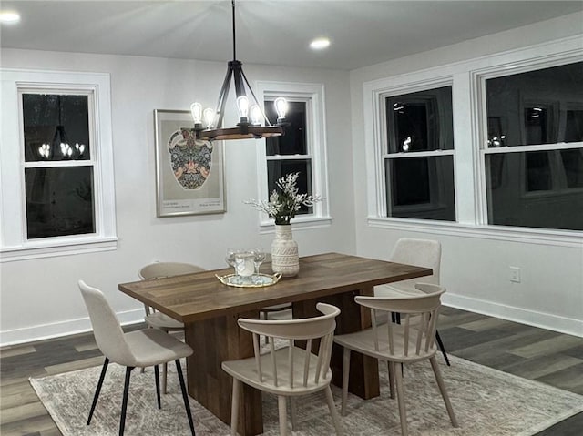 dining space featuring a chandelier and dark wood-type flooring