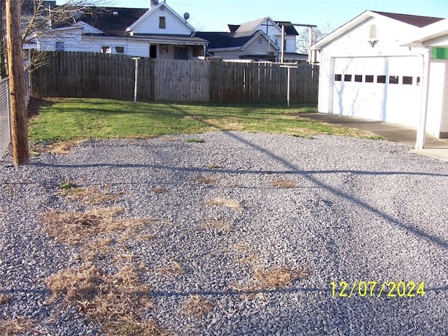 view of yard featuring an outbuilding and a garage