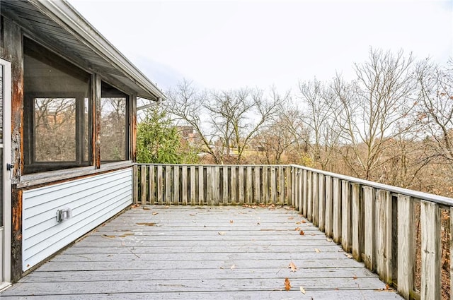 wooden deck with a sunroom