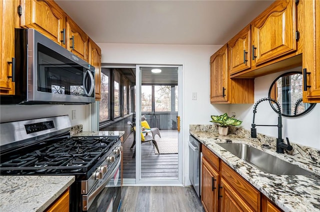 kitchen with dark wood-type flooring, stainless steel appliances, plenty of natural light, and sink